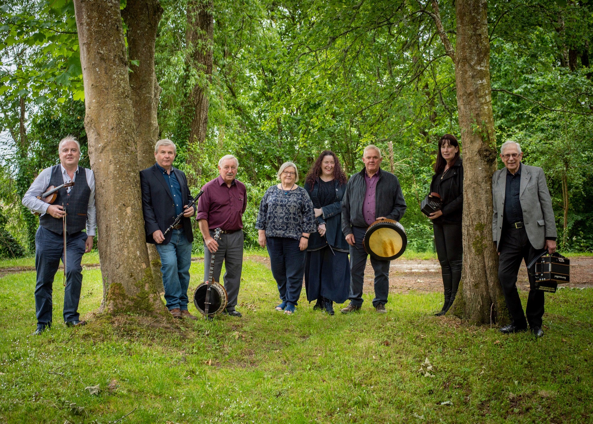The members of Shaskeen, standing amongst some trees.