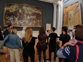 Group listening to a tour guide inside a room in an art gallery