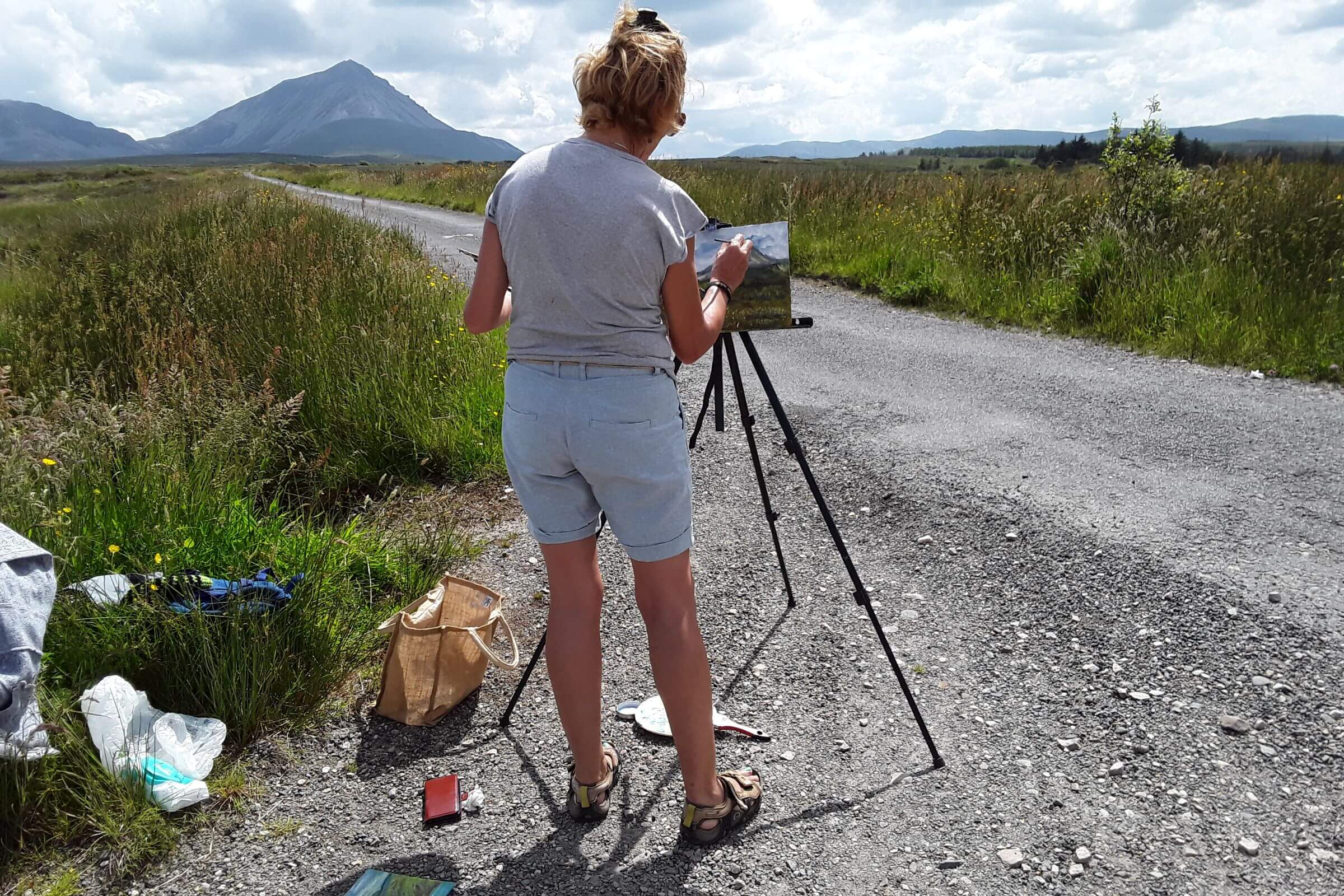 Woman painting the scenery at Gaeltacht Thair Thir Chonnaill in County Donegal