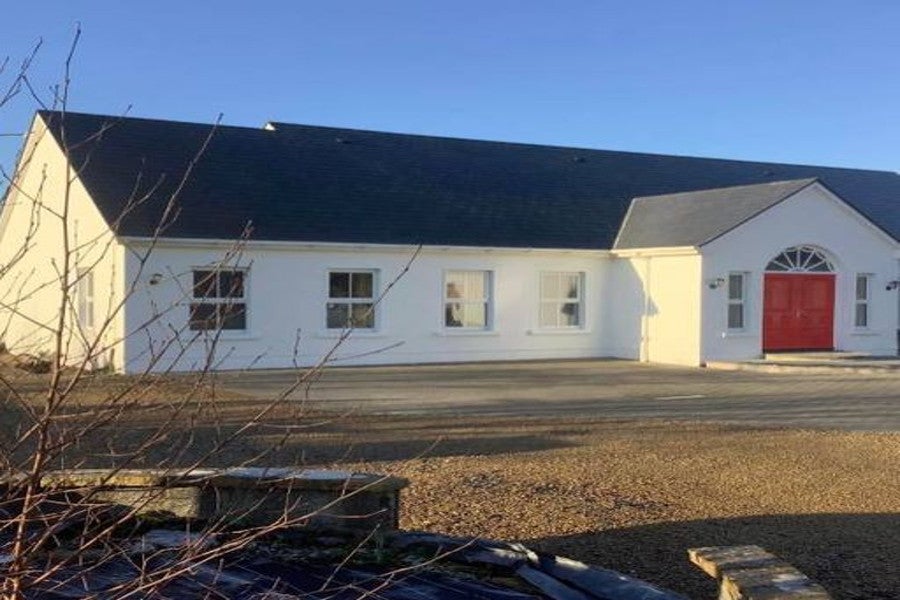 Exterior of property with red front door.