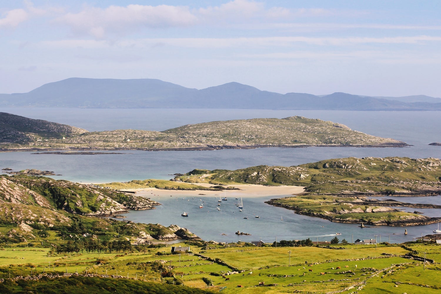 A coastal view with a headland and beach in the distance