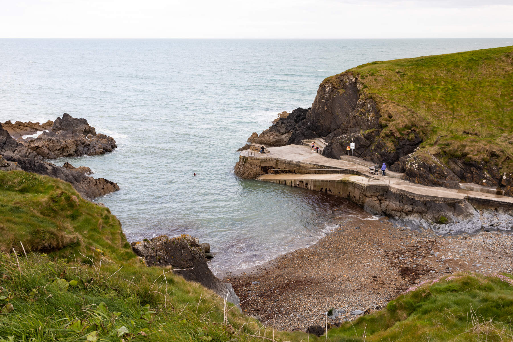 Looking down on a cove with a pier