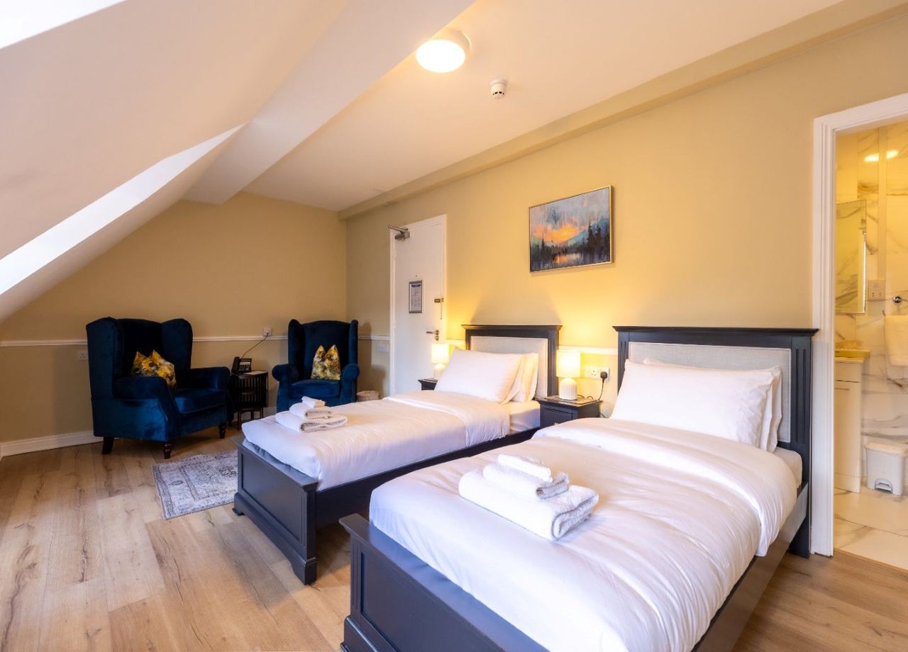 Bedroom with two beds and seating area