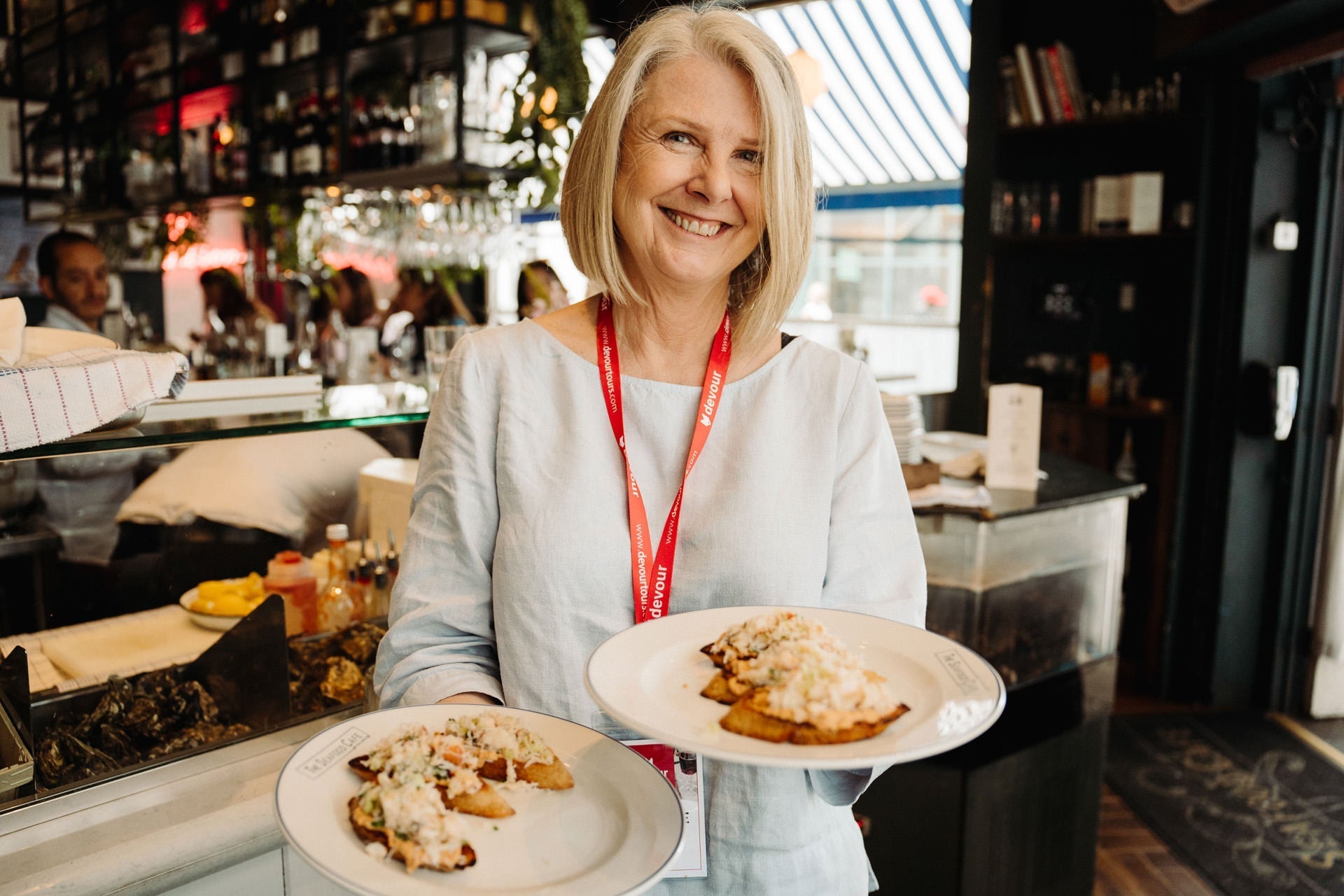 A lady holding two plates of food