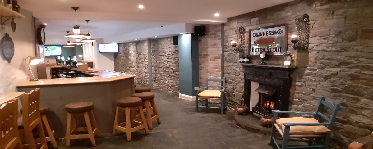 View of the fireplace and bar