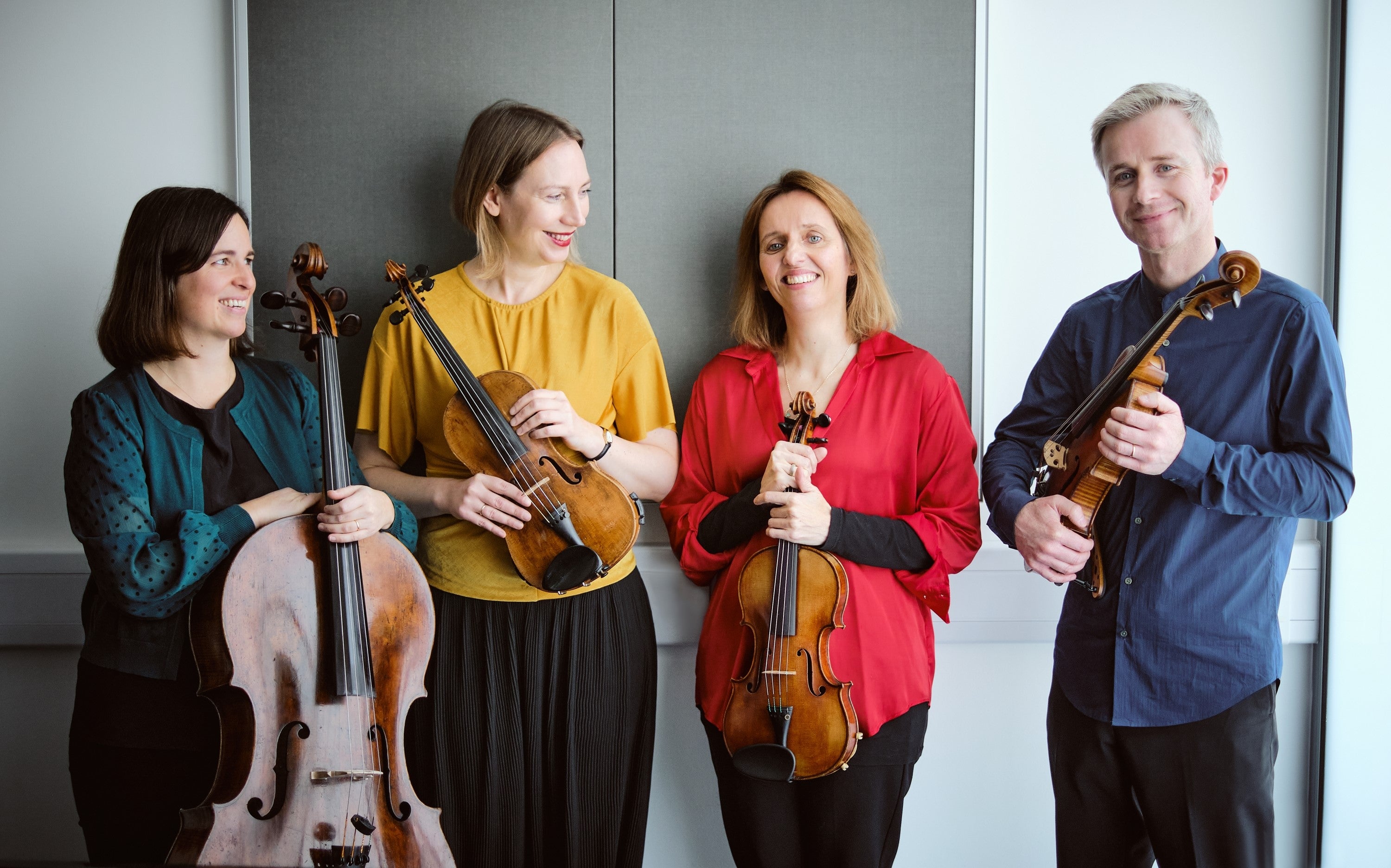 The members of the Solas Quartet smiling and holding your instruments.