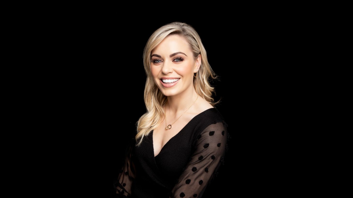 Headshot of Anna Geary on a black background