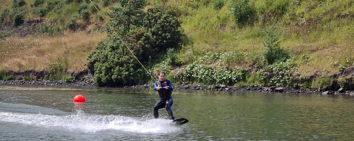 Image of a girl wakeboarding on a lake
