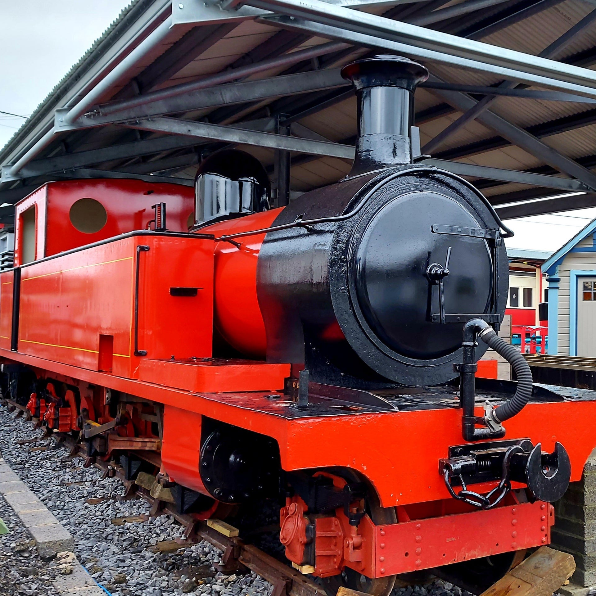Red and black train on a railway track