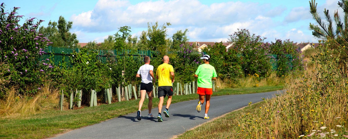 Three guys out jogging in Nature Park