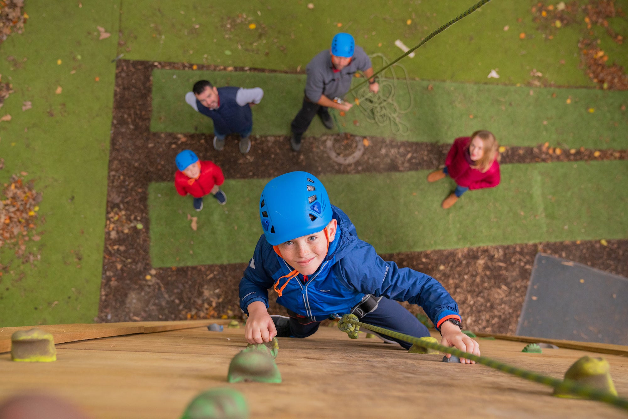 A little boy rock climbing at Russborough House and Parklands in County Wicklow.