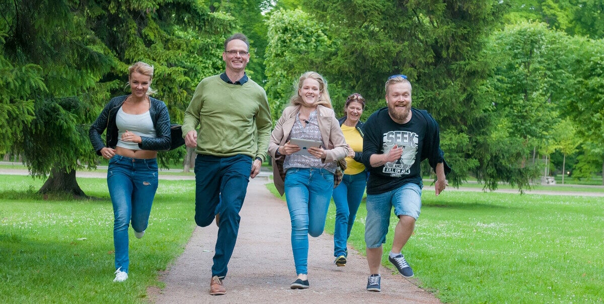 Group of five running through park