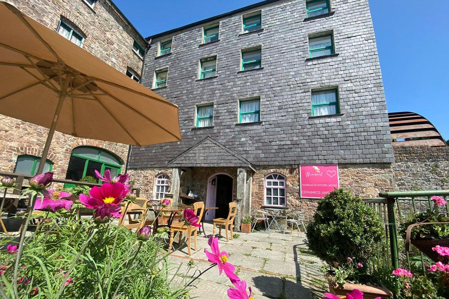 Image of outdoor patio area in front of old mill