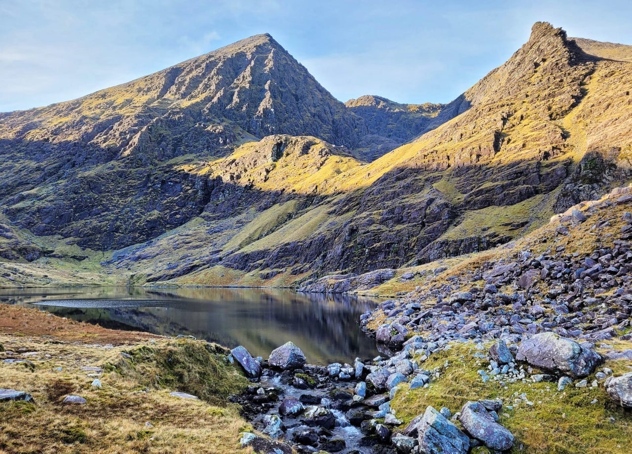 A view of a mountain with a rocky and boggy landscape
