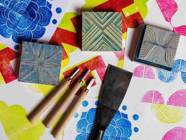 Print & Pattern with Susan Leen - Looking down at table containing print blocks, carving tools and paper with different coloured shapes on.