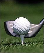 A club striking a golf ball