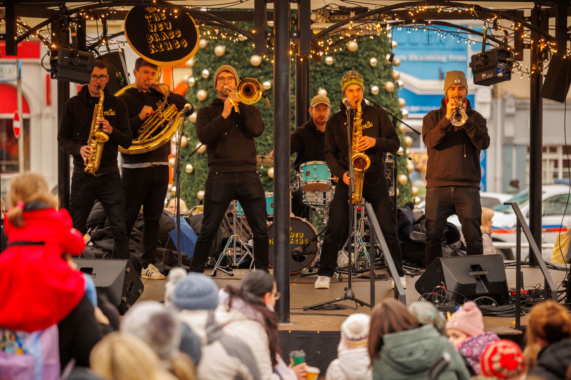 The New Brass Kings play on the 2023 Yulefest Kilkenny Bandstand with onlookers enjoying the festive performance!