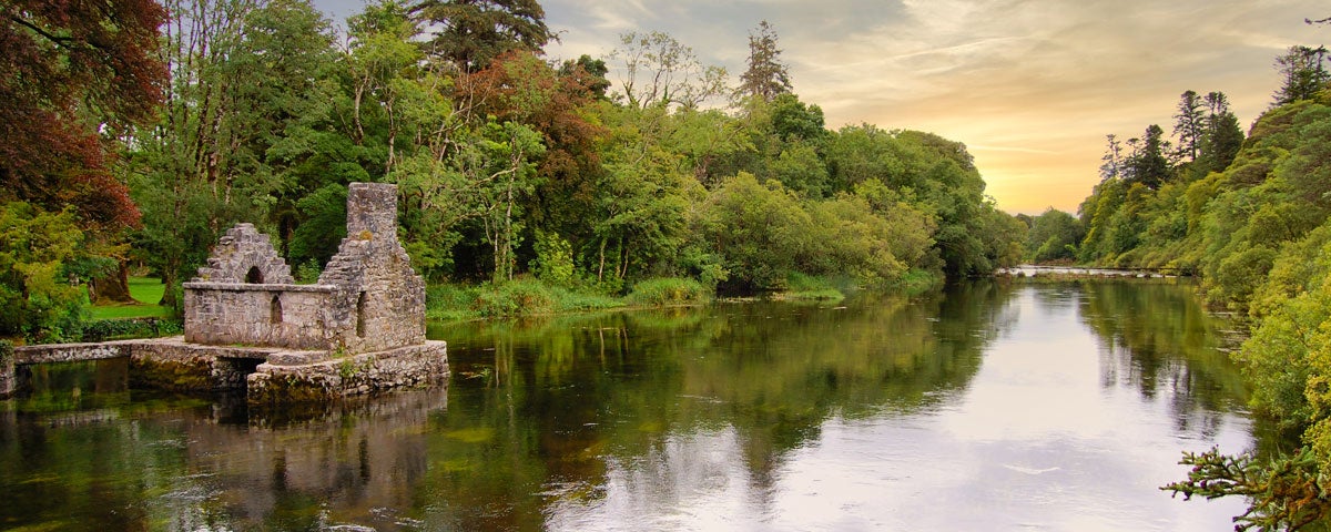The ruins of a stone house beside a river