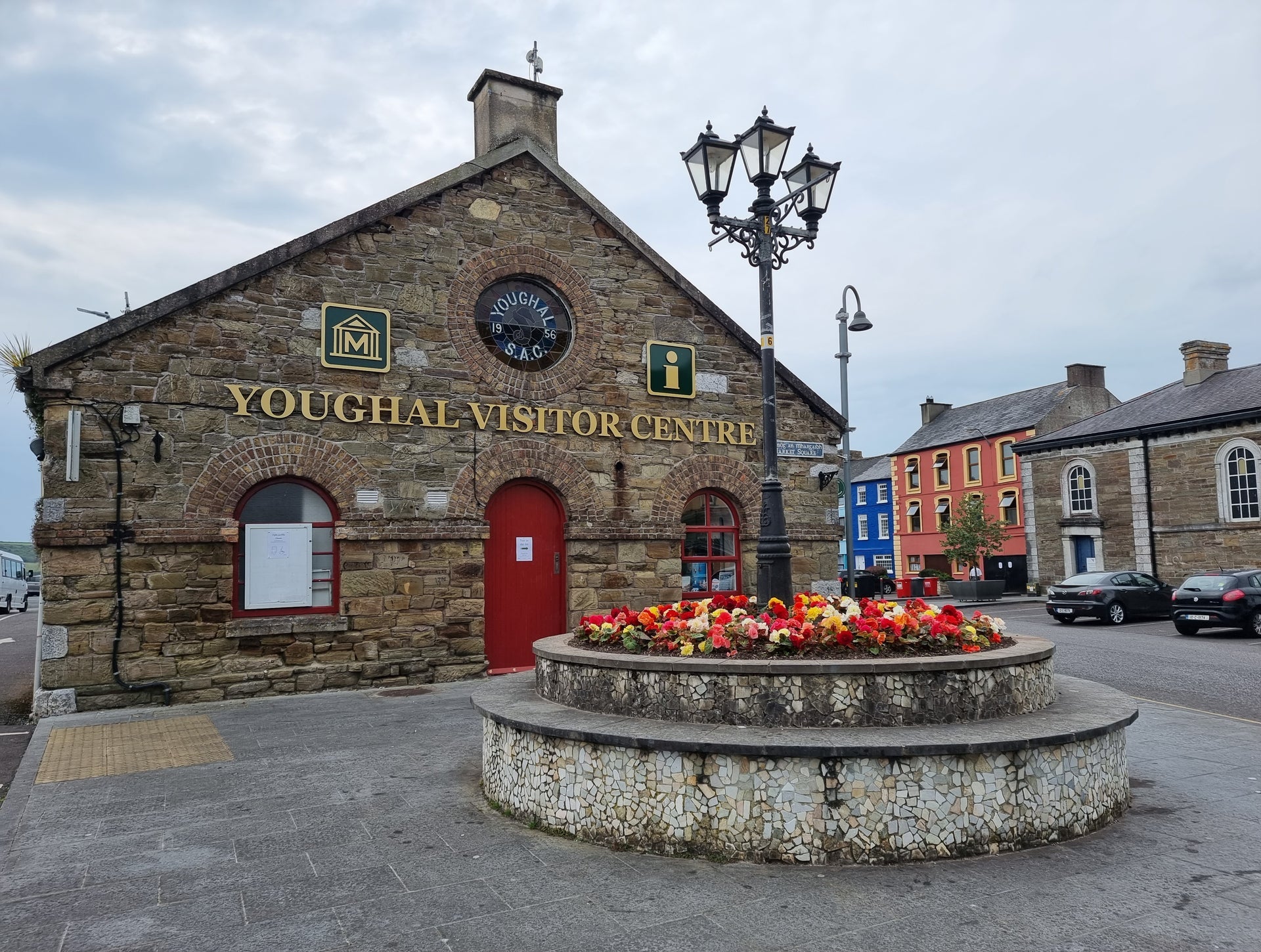 The gable end of a stone clad building with Youghal Visitor Centre in lettering across the roof line level