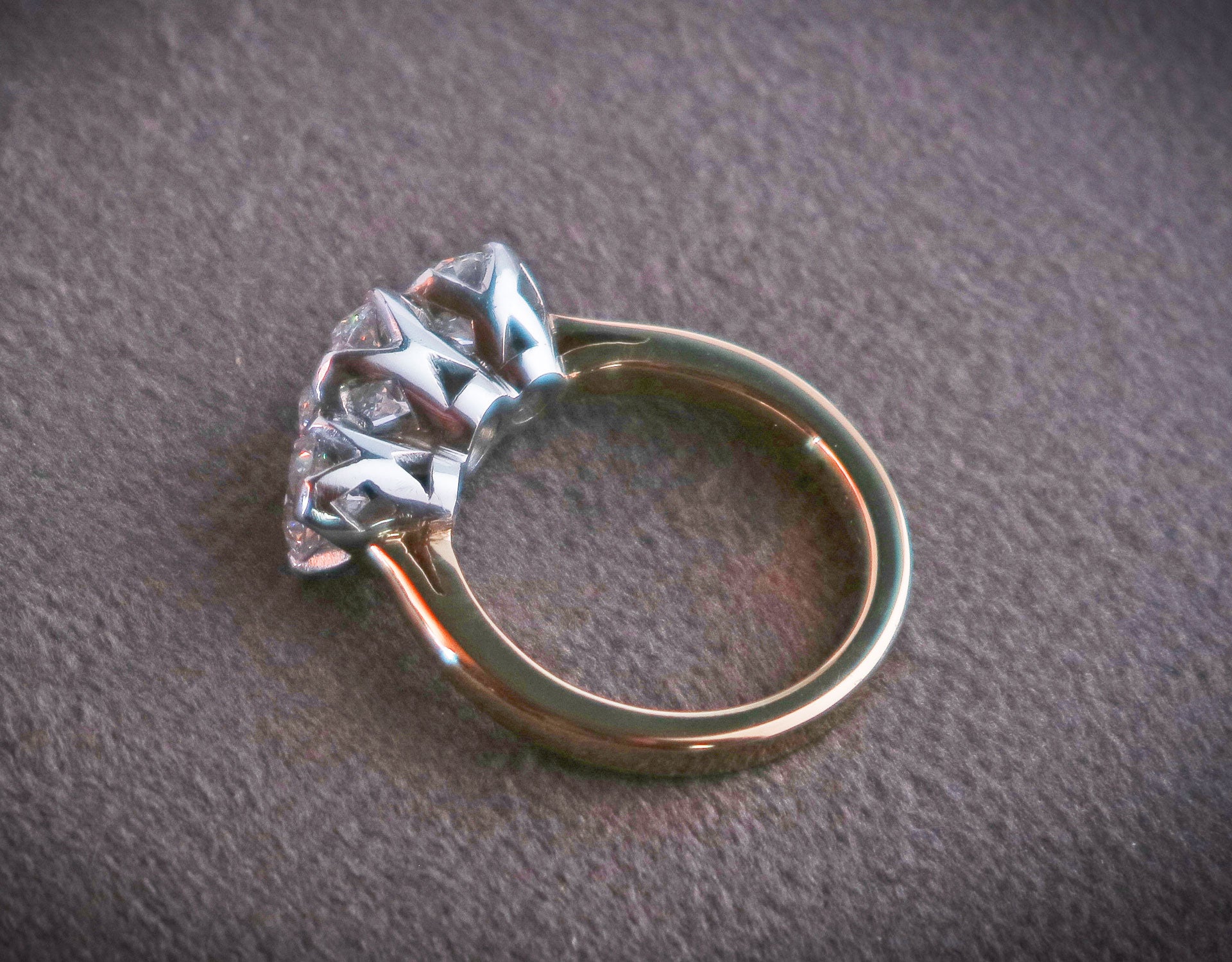 Tiffany Budd Goldsmith ring with gold band and three diamonds set in elegant silver mounts