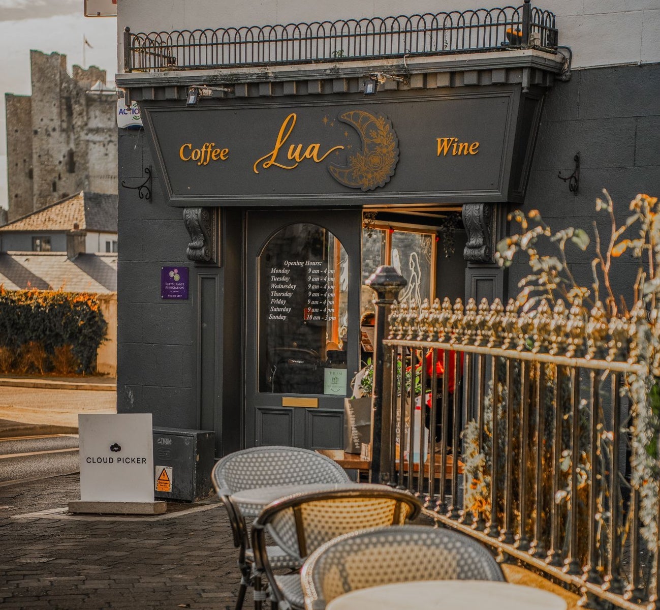 Café entrance with outdoor seating area overlooking Trim Castle