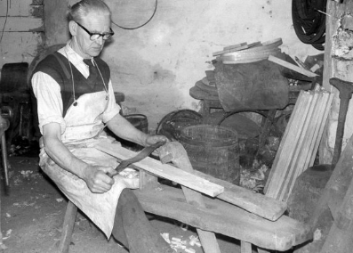 Cooper: Mr. Richard Wadding, Killinick, Co. Wexford, making a barrell for the National Museum.  Hollowing stave on mare with hollowing knife.