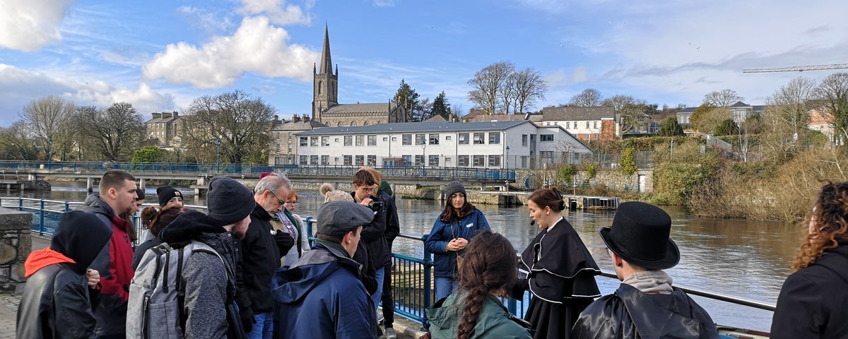 A group of people led by a guide in costume on the Sligo Dark Tales Tour