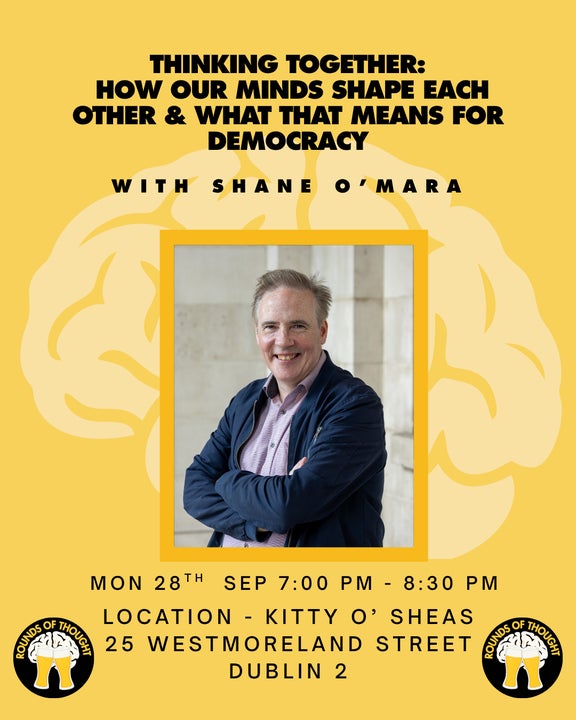 Poster in yellow with image of smiling man with arms crossed.