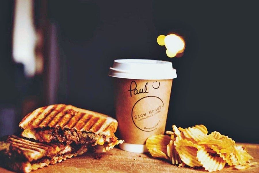 Close up image of a toasted sandwich coffee and crisps