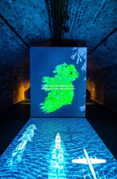 A green map of Ireland illuminated on an interactive table top display