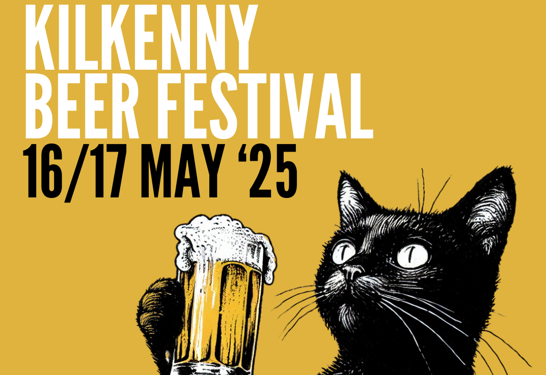 A black cat holding up a large glass of yellow beer, against dull yellow background with white or black text.