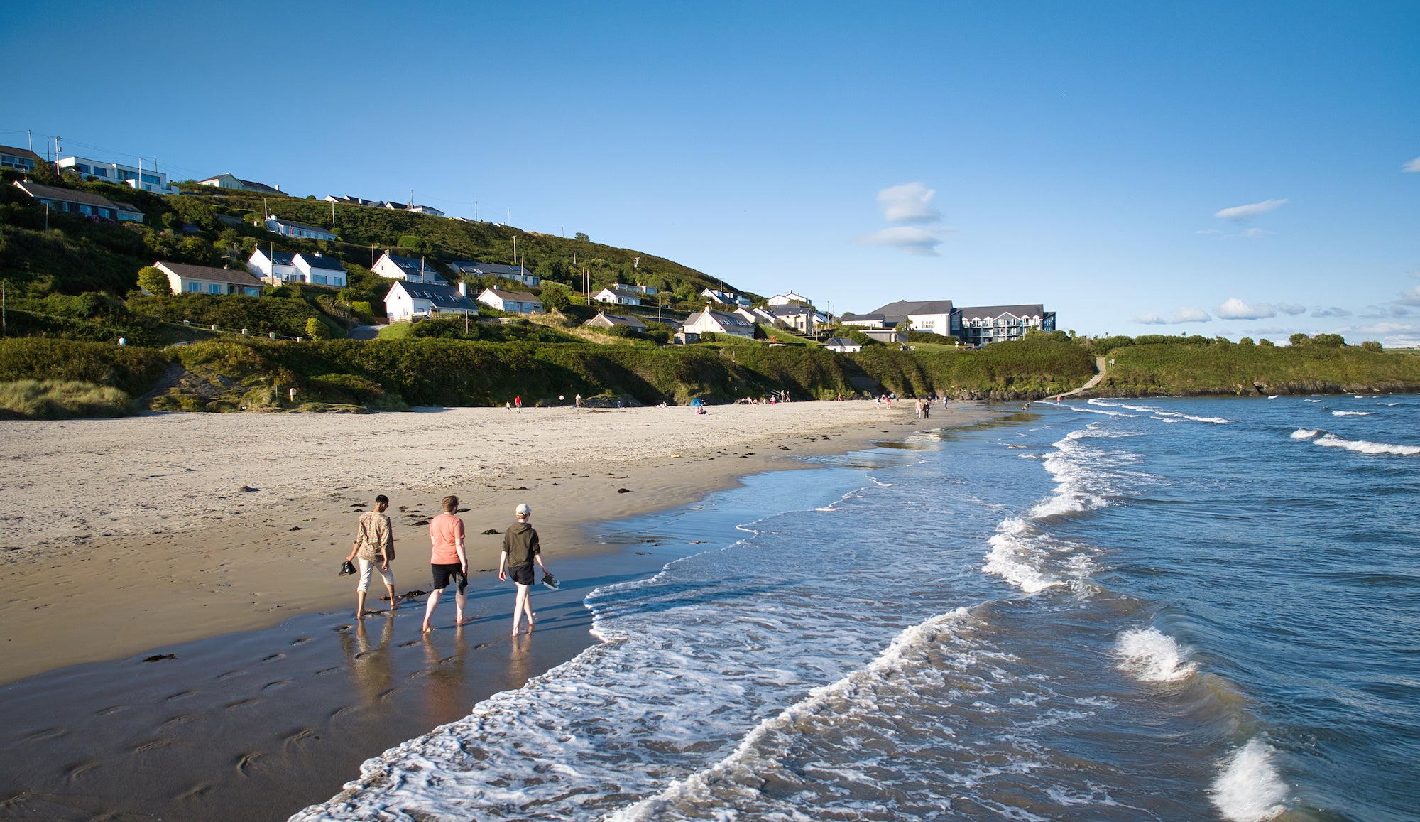 Aerial view of people walking on Incydoney Beach in County Cork