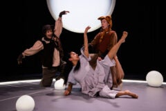 3 people dancing on a stage