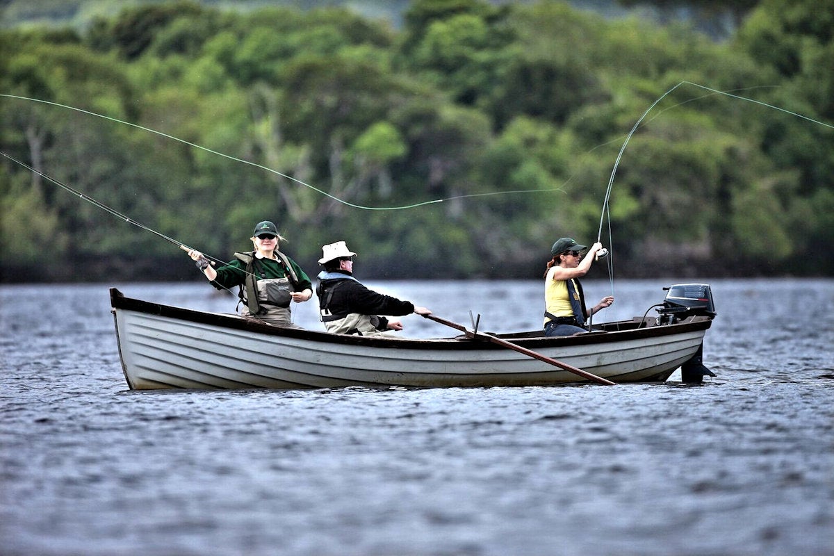People fishing off a small boat in the Lakes of Killarney with Anglers Paradise Fishing Guides Killarney