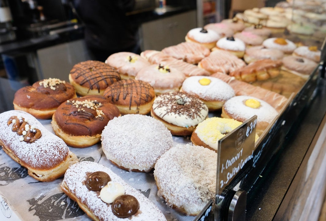 A selection of colourful doughnuts in a shop