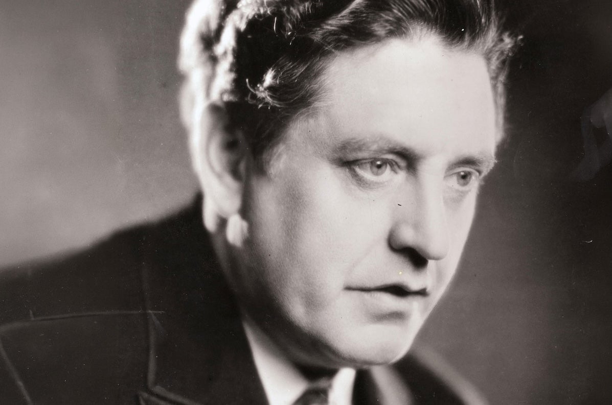 An old photo of head shot of a serious looking man