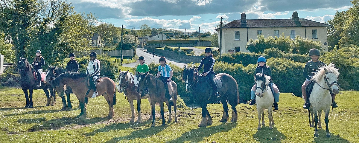 Boskill Equestrian Centre group of children outdoors on horses