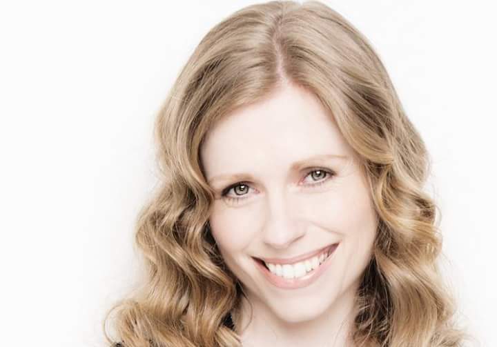 Fionnuala Moynihan is smiling in front of a white background.