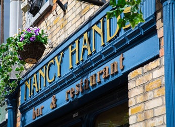 The blue and gold exterior of Nancy Hands Bar & Restaurant