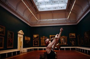 Dancer in the Shaw room, National Gallery of Ireland. Arms raised through a circular horn instrument.