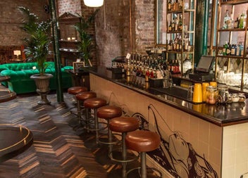 Copilot said:

Bar area of Idlewild exposed brick walls and mirrored shelving