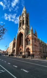 The exterior of a large church featuring a tall tower