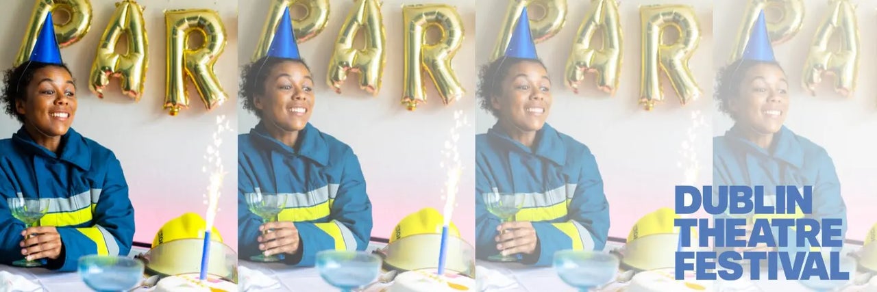 Lola, a firefighter, sits surrounded by birthday decorations