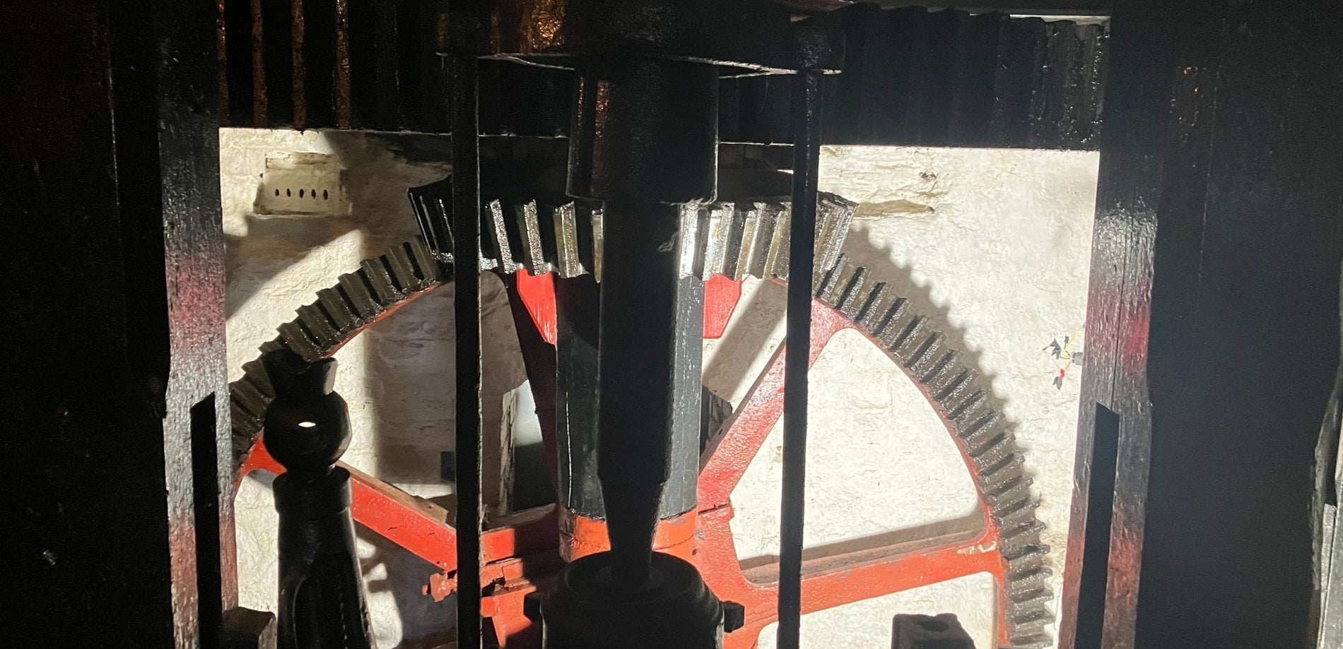 A close up of a metal wheel in a mill