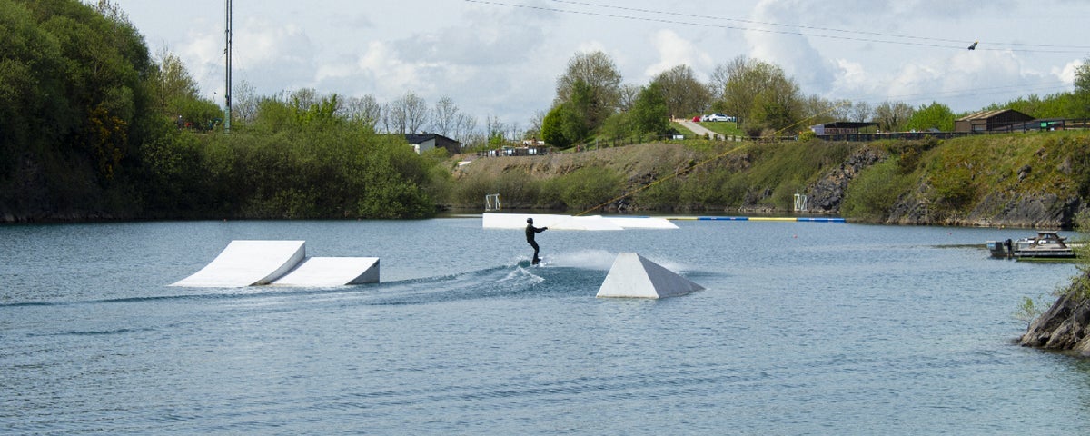Someone wake boarding on a lake