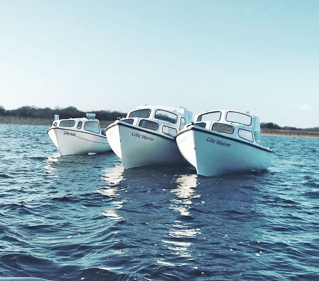 Lakeside Day Boat Tour view of three boats on the water