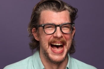 A man laughing with his mouth wide open.