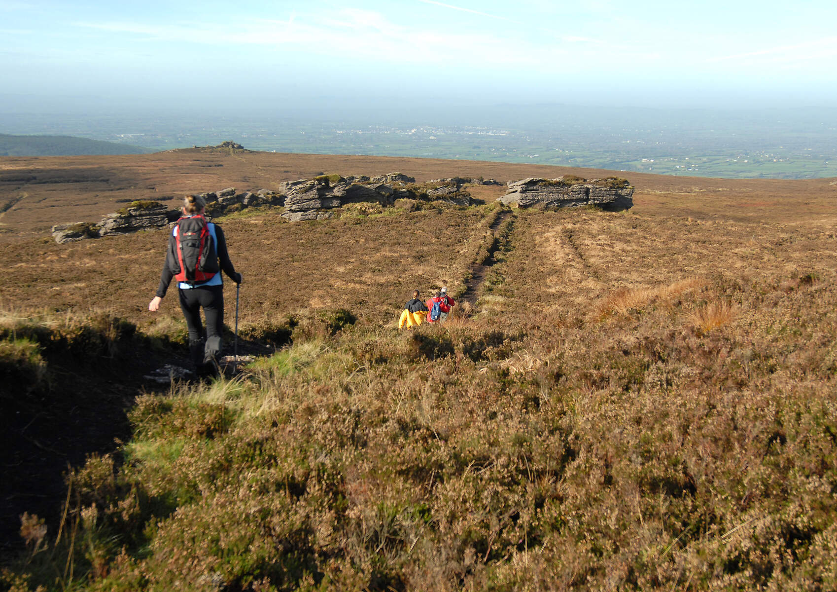 Walkers on a mountain with view into the countryside