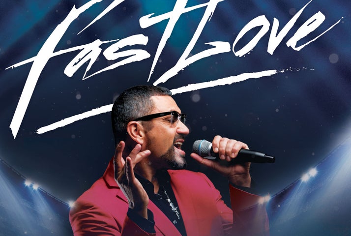 A man in sunglasses is singing into a mic