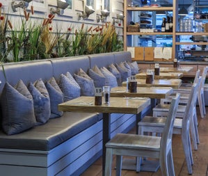 The interior of a café with bench seating and cushions
